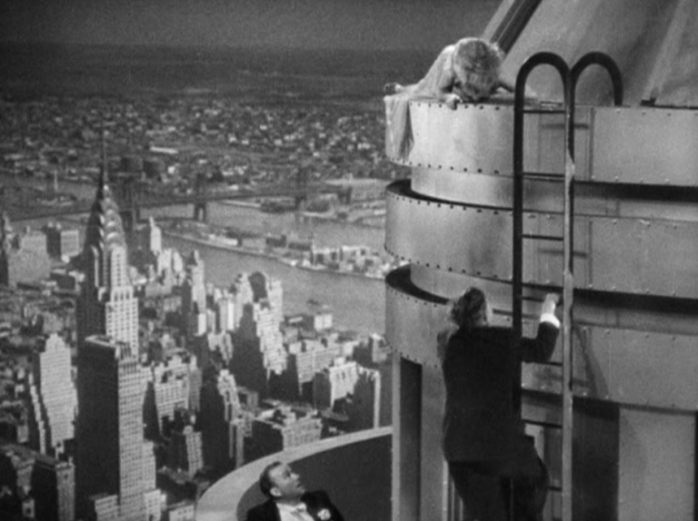 Fay Wray being rescued by Bruce Cabot while Robert Armstrong watches from the 103 floor terrace. 