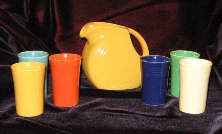 The Fiestaware promotional juice set of 1939. Yellow pitcher and six tumblers in the original colors.
